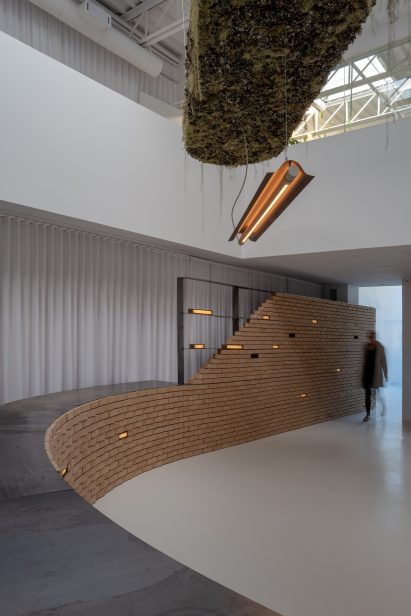 Brick light in installation with mossy chandelier
