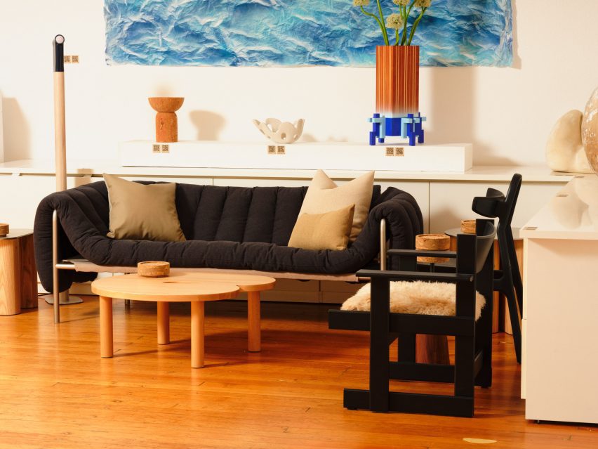 A couch and chairs in a room with wood flooring