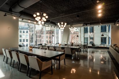 A room with long tables and chairs