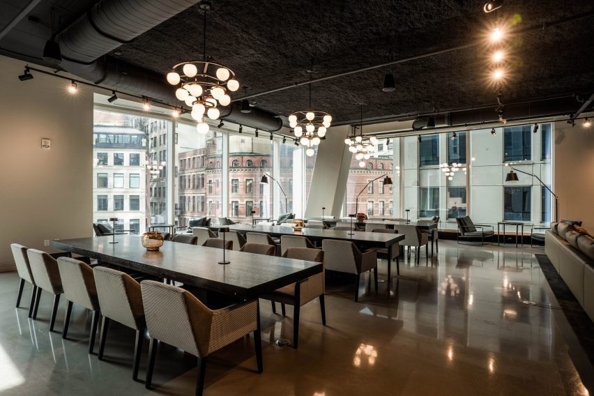A room with long tables and chairs