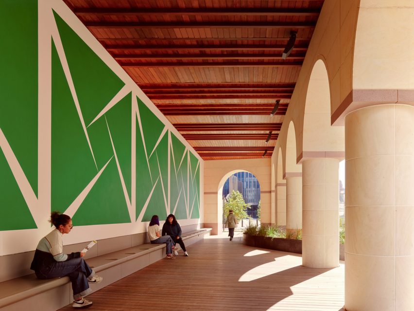 A large green mural underneath a loggia