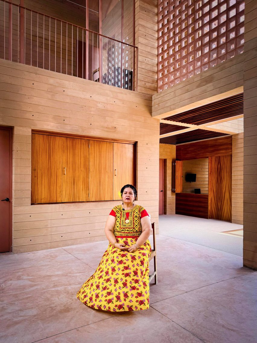 A woman sitting in the centre of an empty building