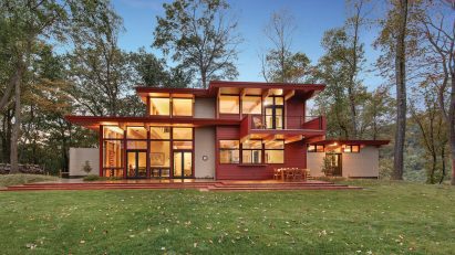 A red house with deep eaves and large windows