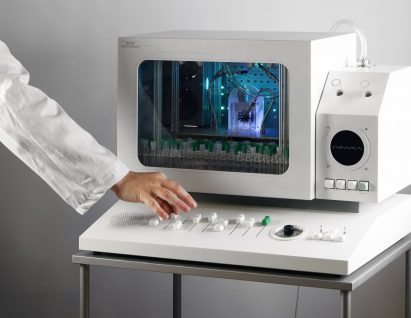Photo of the Future Fan Stage with an arm dressed in a white lab coat nudging one of the faders