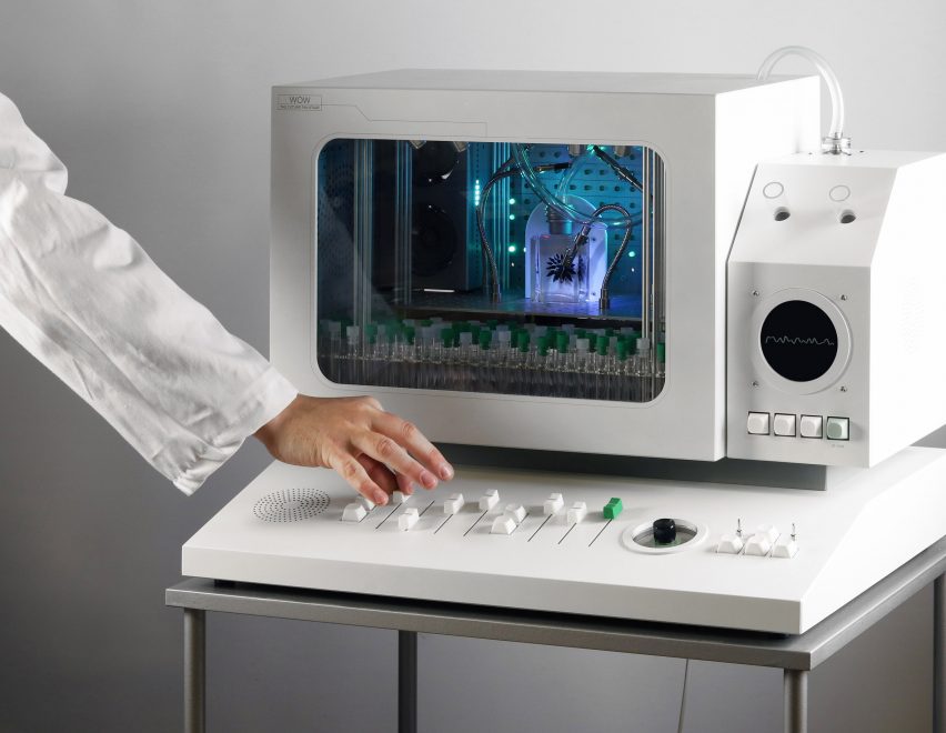 Photo of the Future Fan Stage with an arm dressed in a white lab coat nudging one of the faders