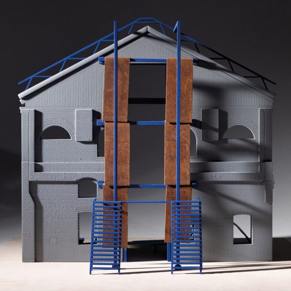 A photograph of an architectural model, in tones of grey, brown and blue, against a black backdrop.
