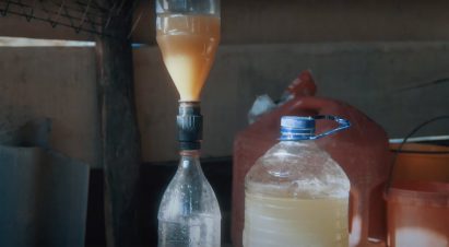 Bottles filled with dirty water connected by a Filter Cap