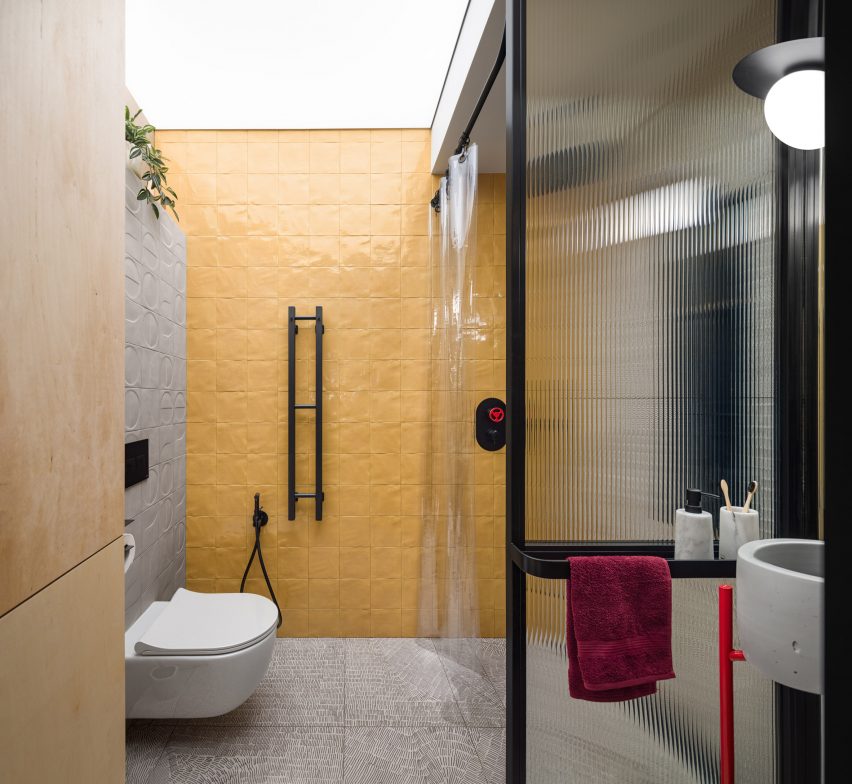 Bathroom in Dihome designed apartment with yellow walls