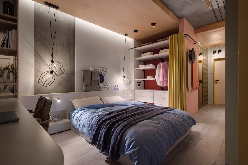 Platform bed with wardrobe and yellow dividing curtain