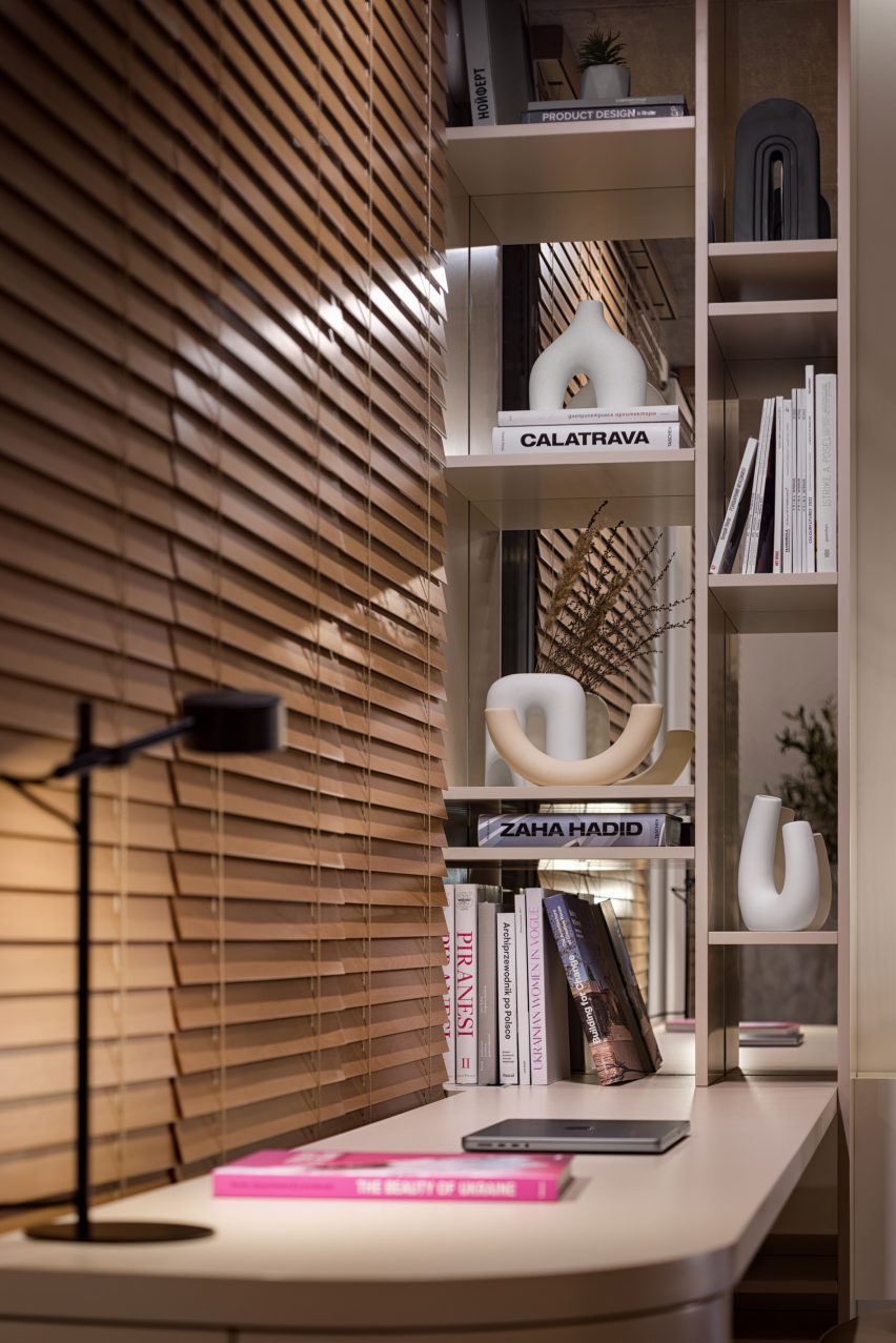 Desk with shelving area and wooden blinds
