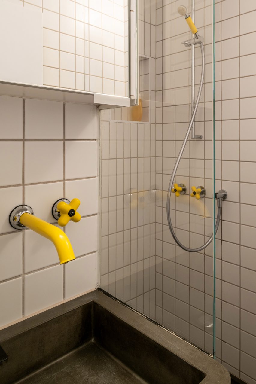 Bathroom with yellow taps in Trellick apartment by Archmongers
