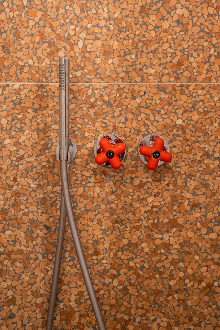 Bathroom with red taps and terrazzo in Trellick apartment by Archmongers