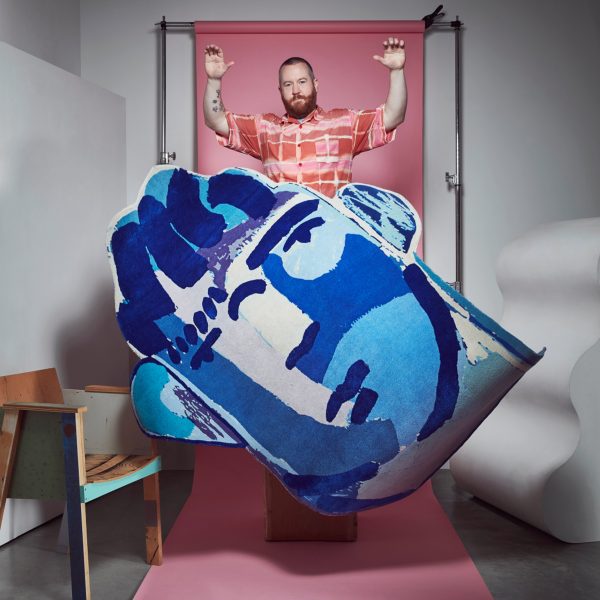 Photo of person holding up a Floor Story rug