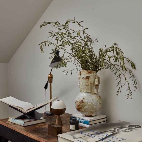 Photo of lamp and vase on a desk