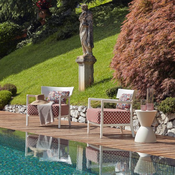 Photo of chairs by Kartell and Liberty by a pool