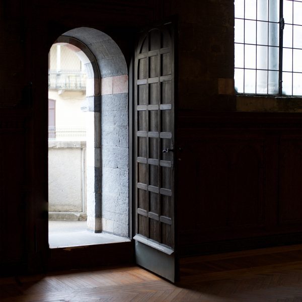 Photo of open door in an arched doorway