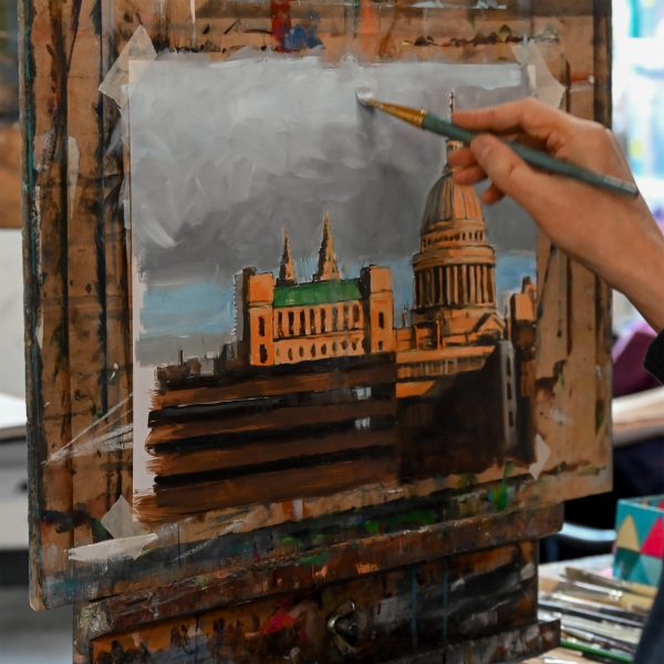 Photo of person painting a building