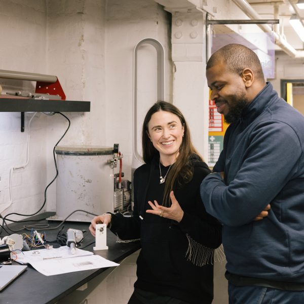 Photo of two people interacting with technical equipment