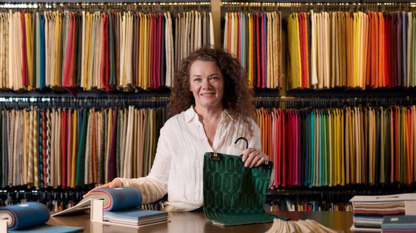 A photograph of a person holding fabric samples