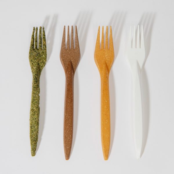 A photograph of four forks made using different natural materials, in tones of green, brown, yellow and white, against a grey background.