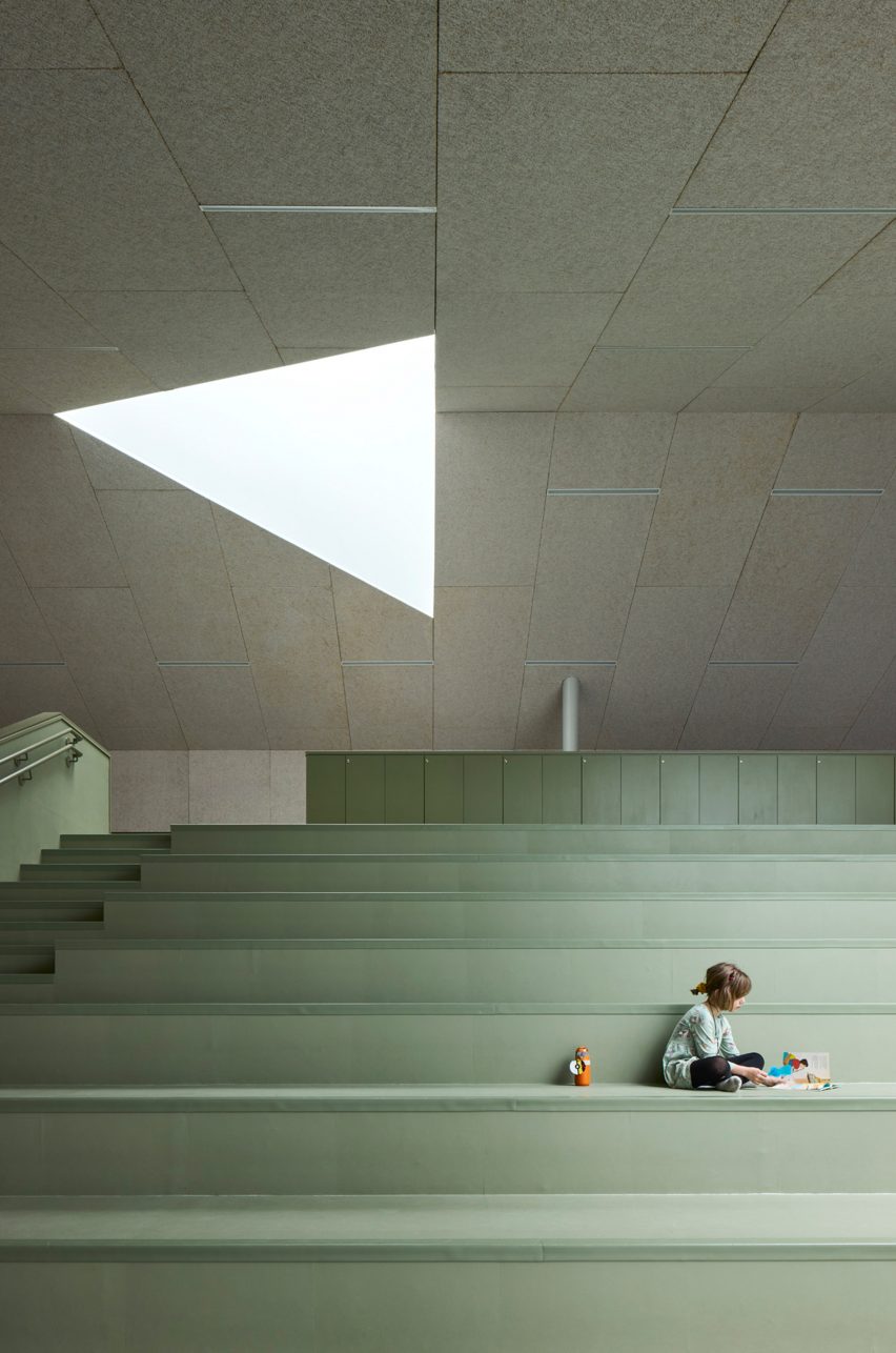 Kid sitting on pastel colored chairs