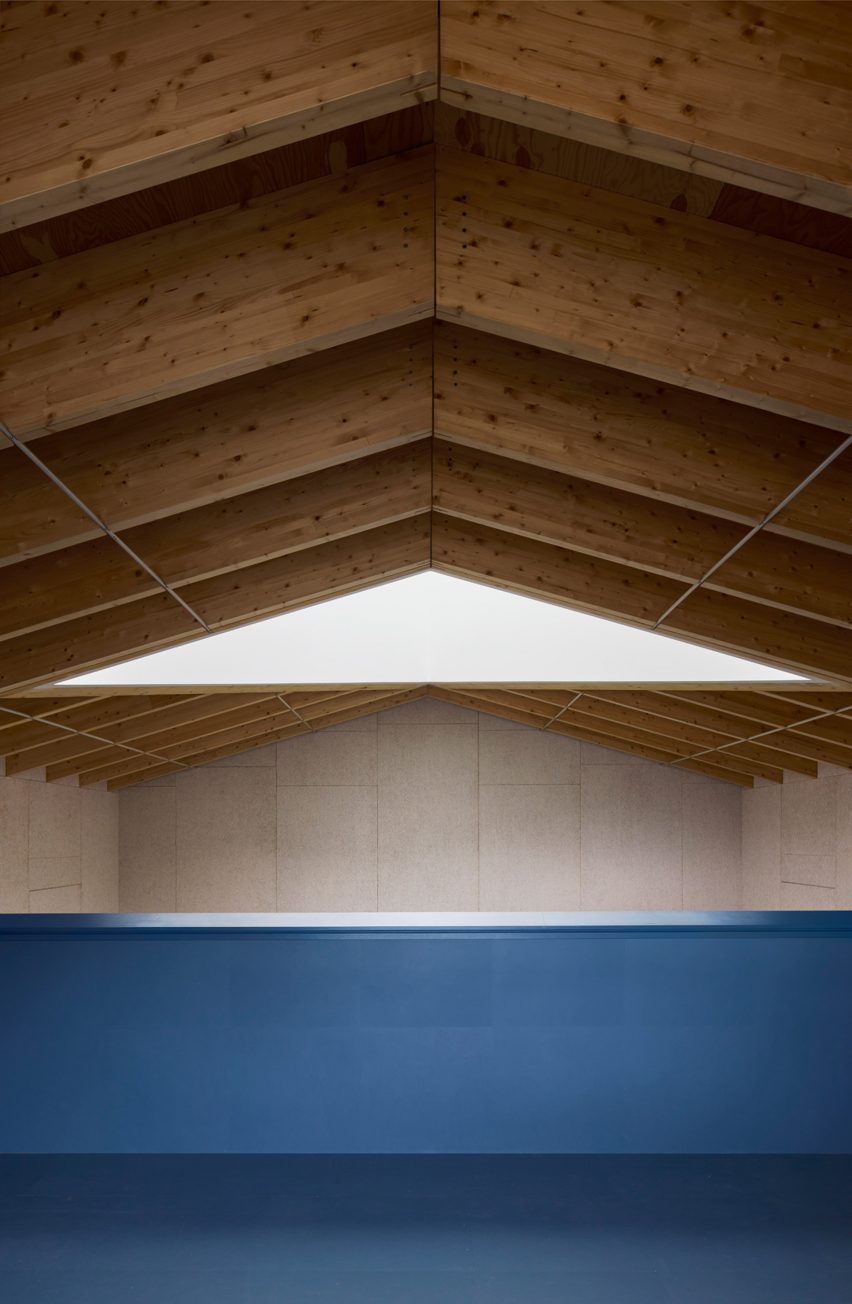 A blue balcony and wooden ceiling
