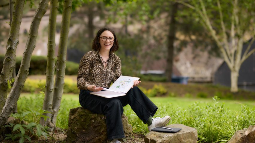 a photograph of a person sketching in a garden