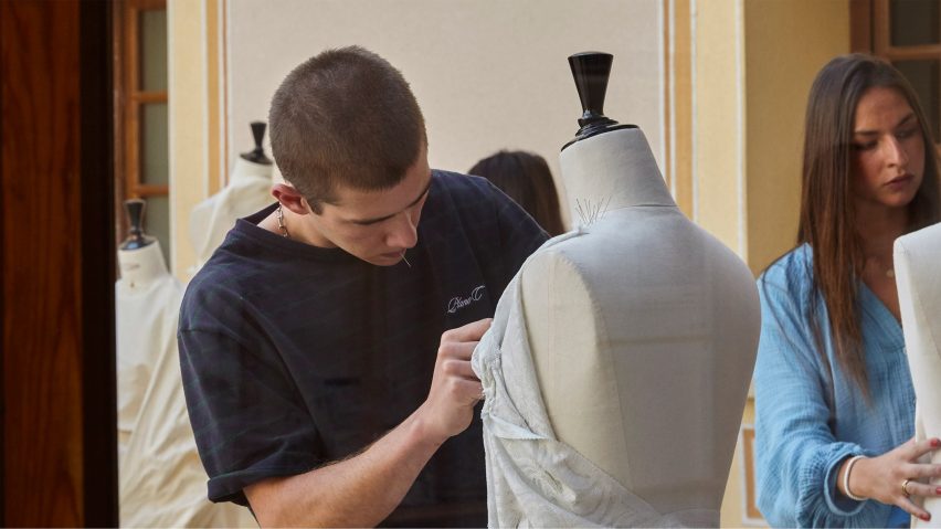 a fashion student working on a design on a mannequin