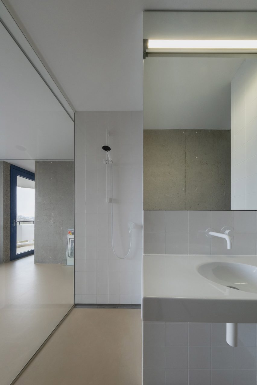 Glass-walled bathroom with white fittings and fixtures