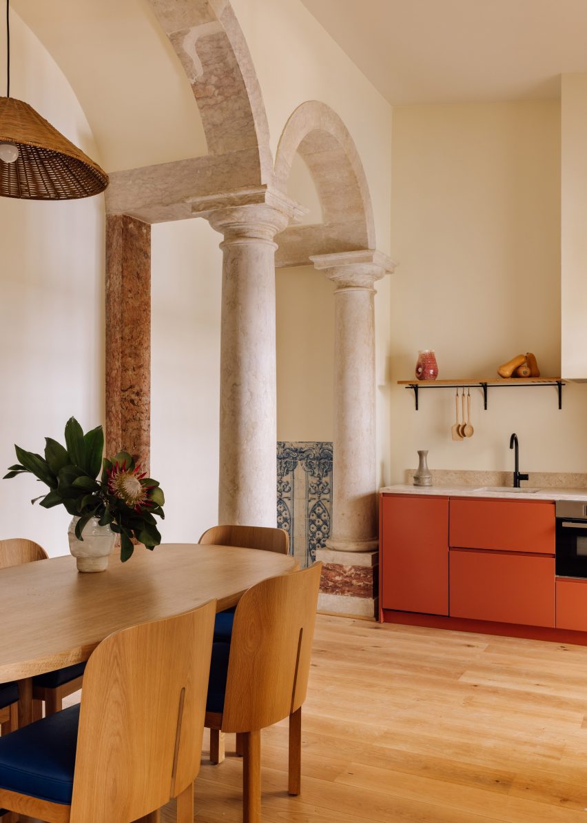 Archways and burnt orange kitchenette in hotel room