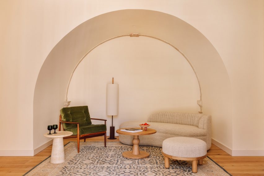 Archway with green and beige chairs below