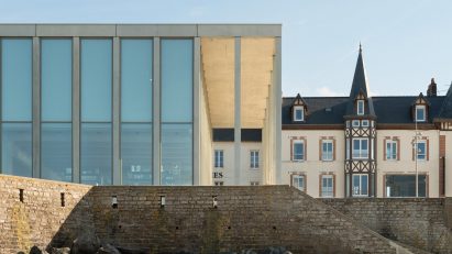 Slim concrete colonnade fronts D-Day Museum in Normandy