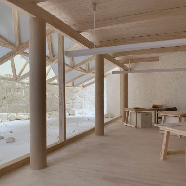 Student work, wooden structure with cylindrical pillars.