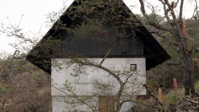 Concrete cabin with black roof
