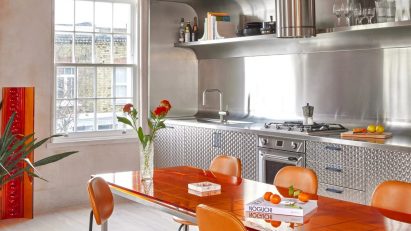 Stainless steel kitchen with orange chairs Holloway Li