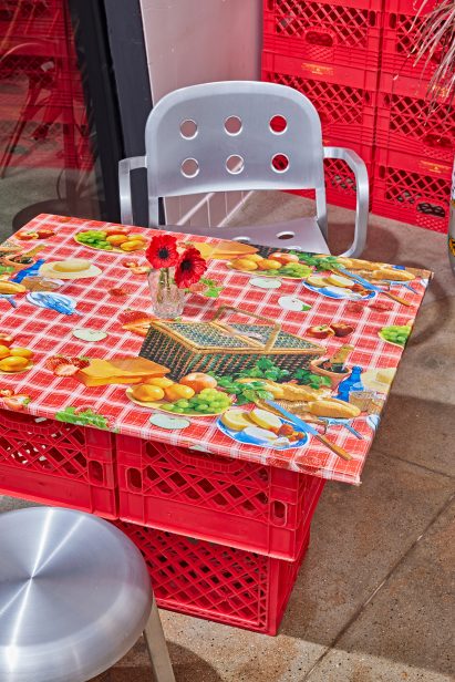 Table made from red baskets and a vinyl wrapped top
