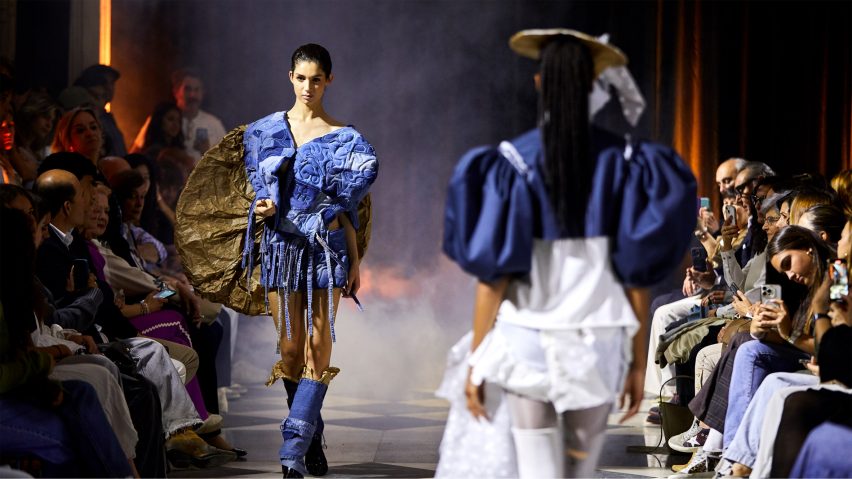 students walking a runway in garments in tones of blue