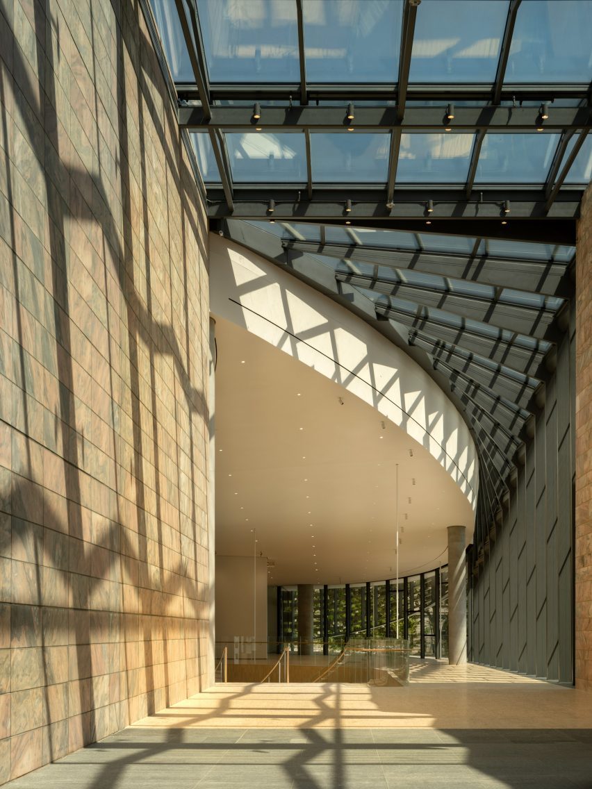 People walking under glass ceiling