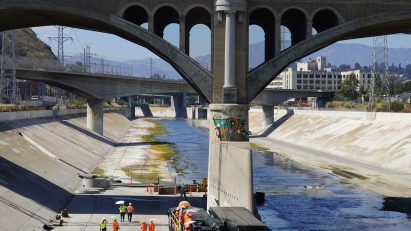 Workers digging a hole in the LA River