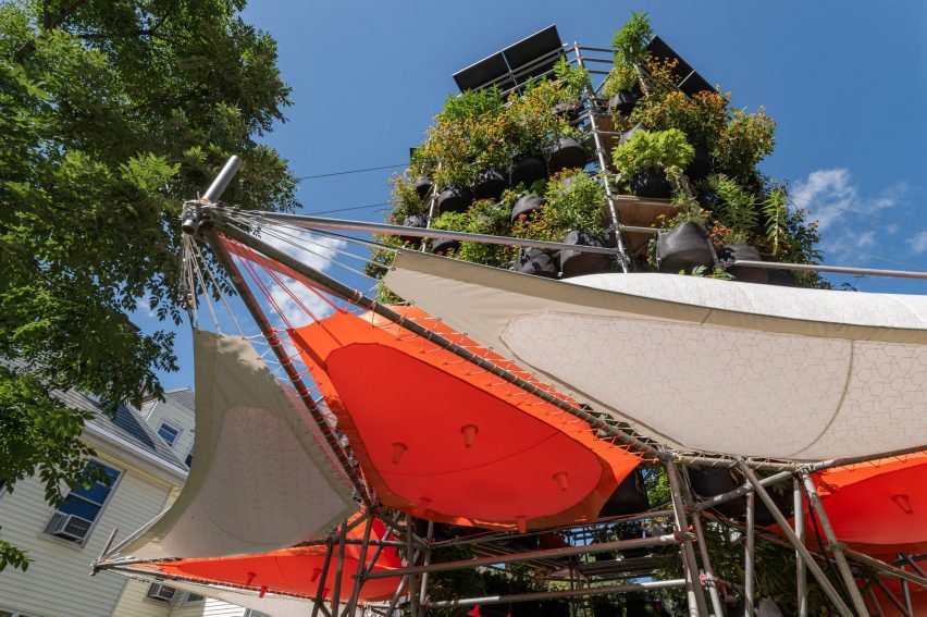 Installation with stacks of plants and tent awnings