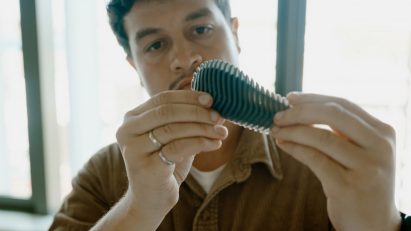 Photo of Richard Alexandre examining the Pyri prototype in close-up