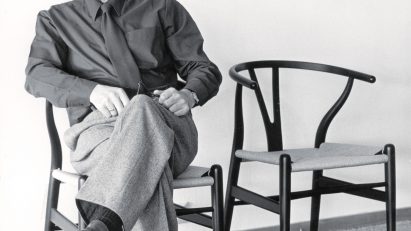 Hans J Wegner on a CH24 Wishbone Chair