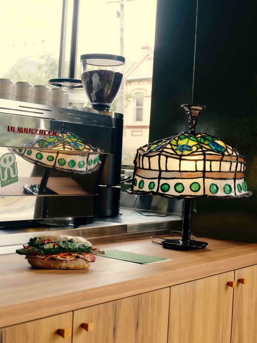 Green lamp by artist Autumn Casey on service counter of cafe