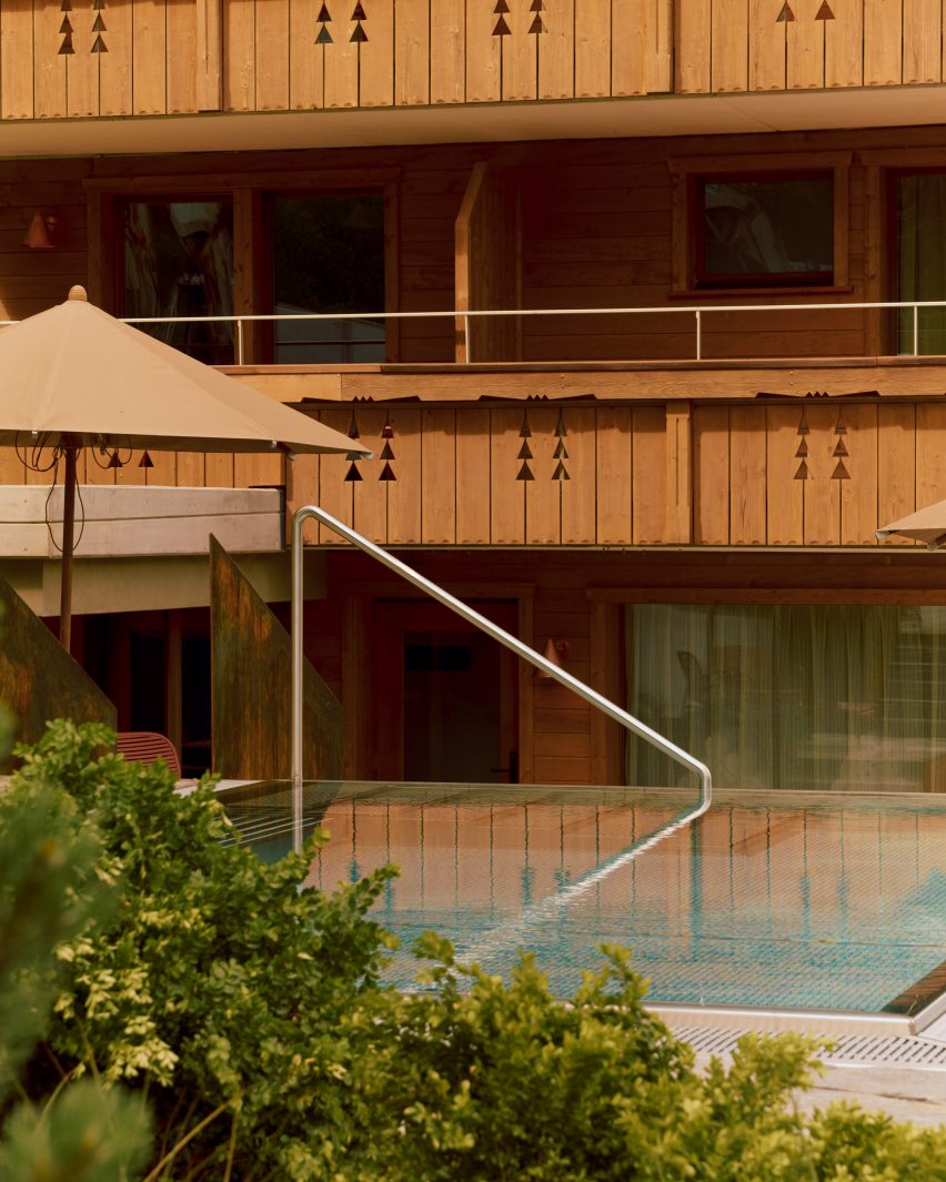 Infinity pool with balconies of chalet behind