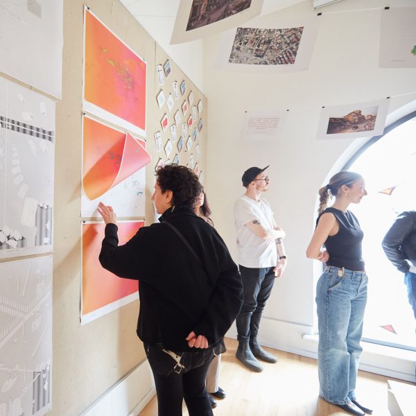 Photograph showing students talking about work that is being exhibited.