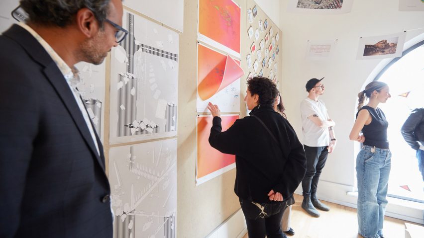 Photograph showing students talking about work that is being exhibited.