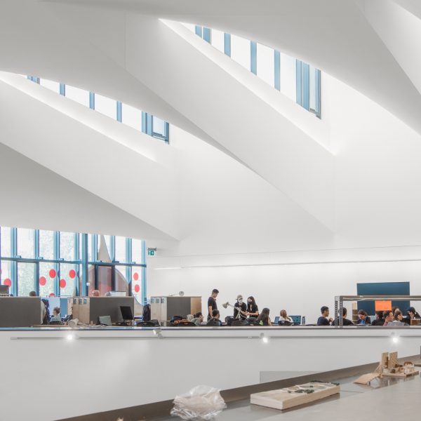 Photograph showing students working in an open plan building.