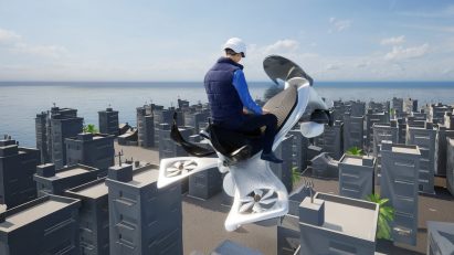 A visualisation of a person riding a white aircraft, above grey buildings below.