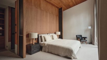 Wood panelled walls of light bedroom in Estonia