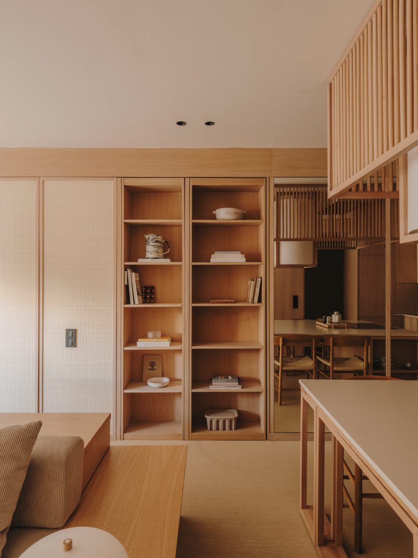 Wood bookcase concealing doorway in apartment